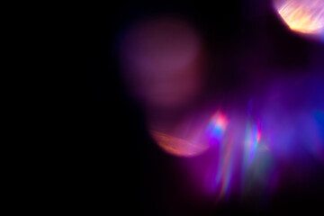 Blur colorful rainbow crystal light leaks on black background. Defocused abstract multicolored retro film lens flare bokeh analog photo overlay or screen filter effect. Glow Vintage prism colors