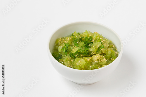 Physalis or tomatillo dip in ceramic bowl isolated on white background. Vegetable salsa verde sauce