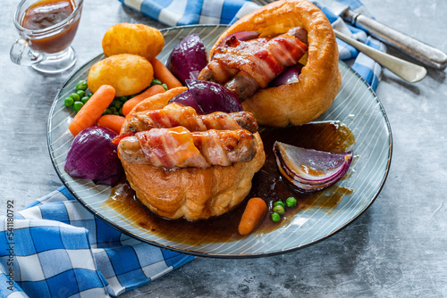 Toad in the hole with Yorkshire pudding, sausages and vegetables photo