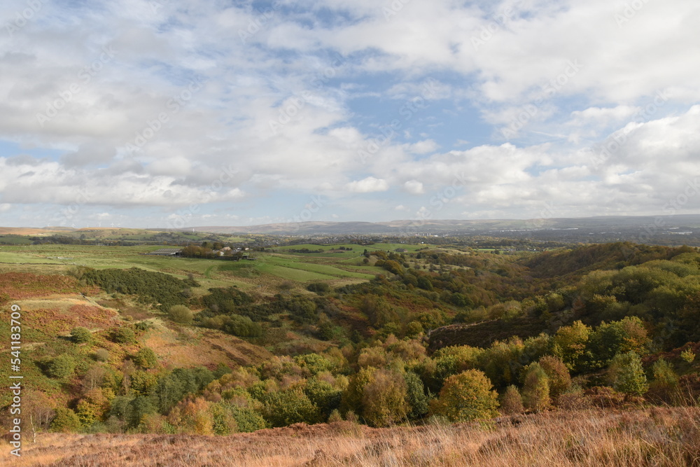 Naklejka premium Countryside views from the top of a mountain with rural farmland and far reaching views. Taken in Bury Lancashire England. 