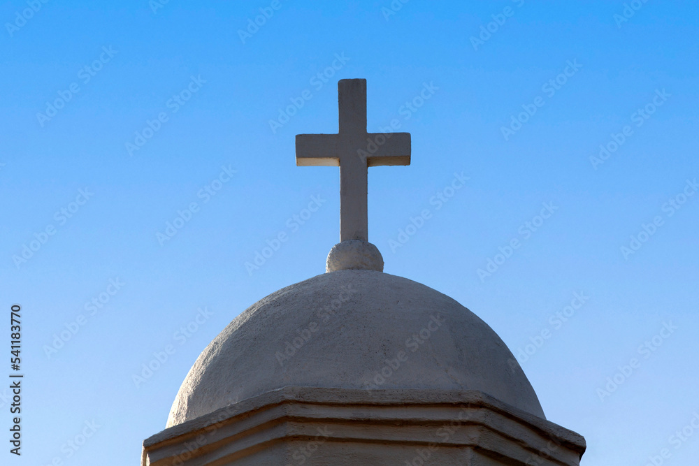 marble cross on the dome of a christian church, against blue sky marble cross on the dome of a christian church, against blue sky