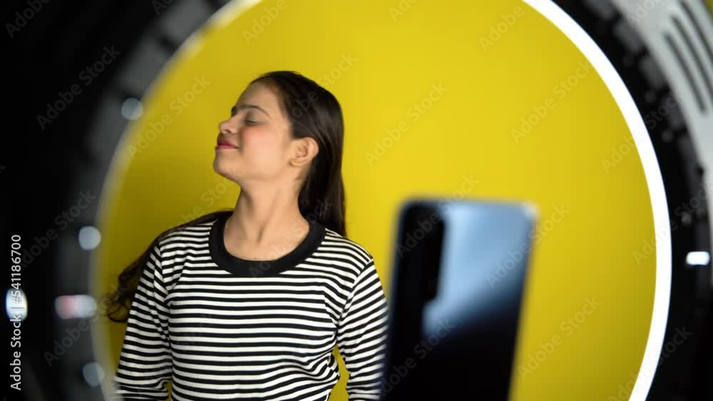 Beautiful young Asian fashion vlogger or blogger making video with ring light and smartphone. Social media or Internet influencer people or content creator.