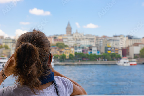 Fototapeta Naklejka Na Ścianę i Meble -  Travel to Istanbul background photo. Tourist woman looking to the Galata Tower
