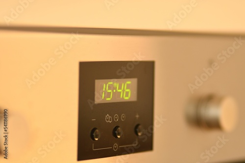 Green LED digital clock on an oven in Germany