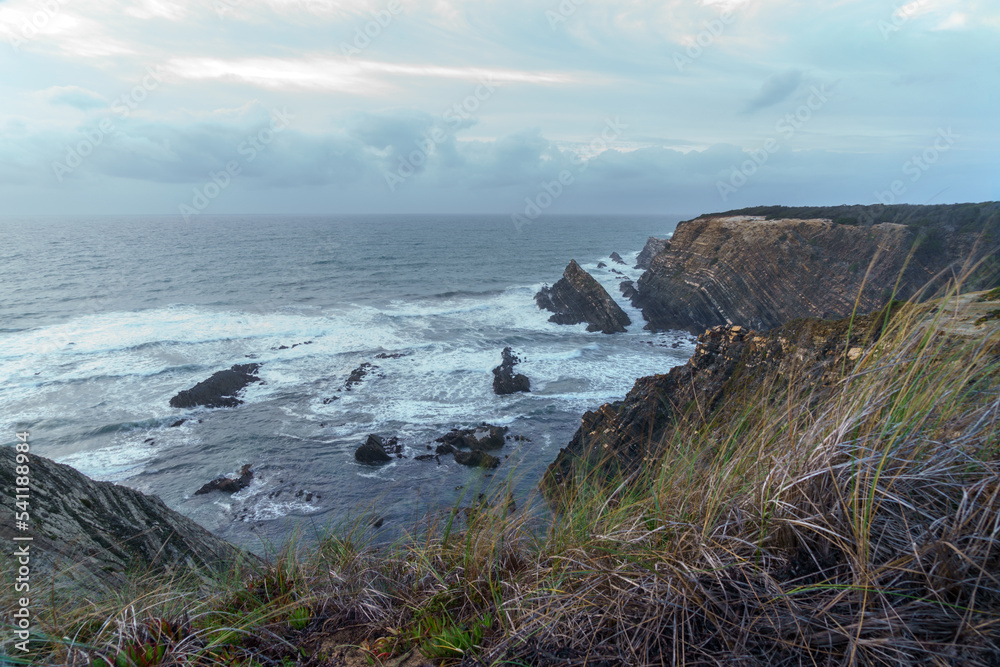 clifftop view looking over a dusk ocean horizon clifftop view looking over a dusk ocean horizon