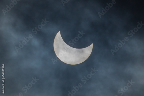 Solar eclipse through a telescope. Photograph of a partial solar eclipse of the Sun's disk by the Moon. Sun spots.