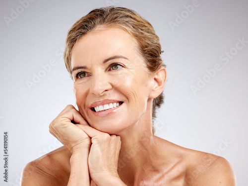 Elderly, woman and skincare with smile, vision and beauty while pose, thinking and happy with studio background. Senior, model and cosmetics for skin, face and body in dermatology, health or makeup