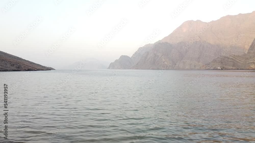 Drone clip of inlet in Oman leading out to sea at sunset Drone clip of inlet in Oman leading out to sea at sunset