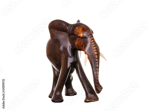 Wooden figurine in the shape of a carved brown wood elephant. Items for decoration, gifts. Decor in the form of a wild animal. Isolated on white background