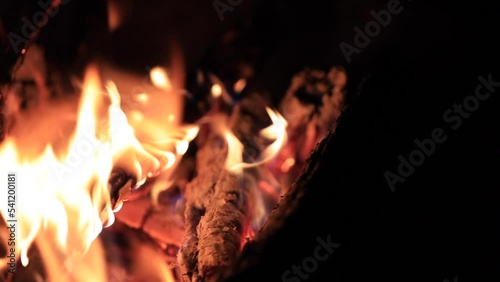 Panning shot of logs burning in a fire pit. photo