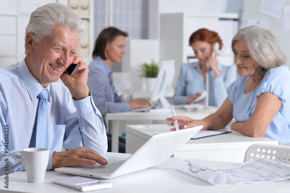 Business man talking on smartphone in modern office