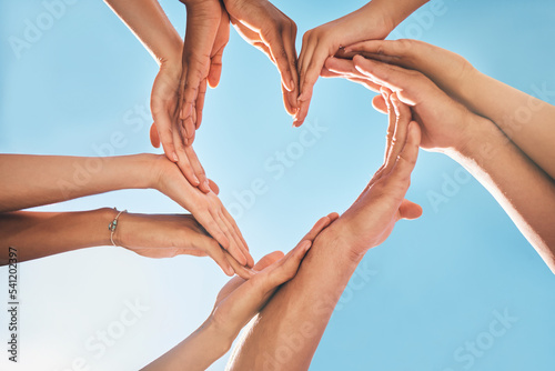 Heart, love and group hands for support, care and community with outdoor summer sunshine, blue sky and mock up. Group of people with care sign for solidarity, health and wellness background mockup