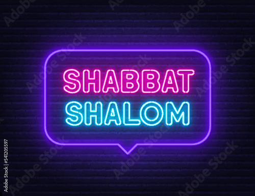 Shabbat Shalom neon sign in the speech bubble on brick wall background.