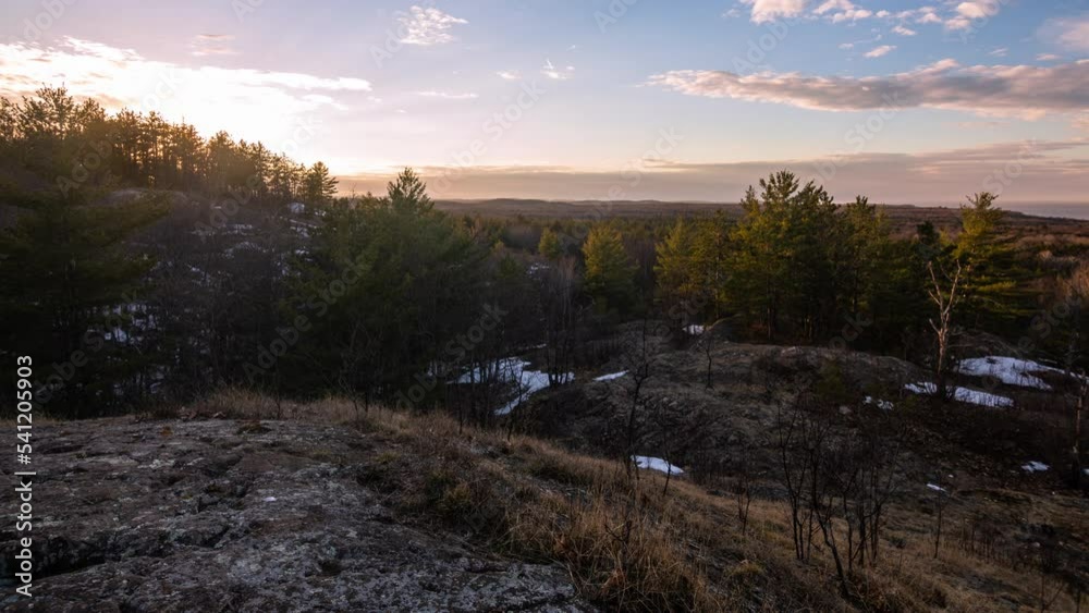 Time-lapse of golden sunset light on forests in late winter.  Shot in Michigan's Upper Peninsula, in 4K