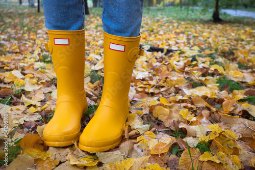 bright autumn. girl in yellow rubber boots walking © Sergii Mostovyi
