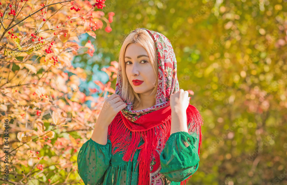 Slavic woman in ethnic embroidered scarf with fringe, flower pattern