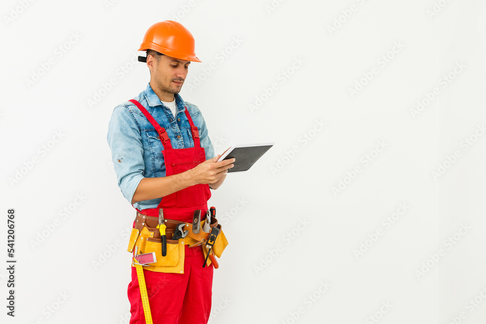 Fototapeta premium Construction Worker with a tablet. Planning Developer Concept