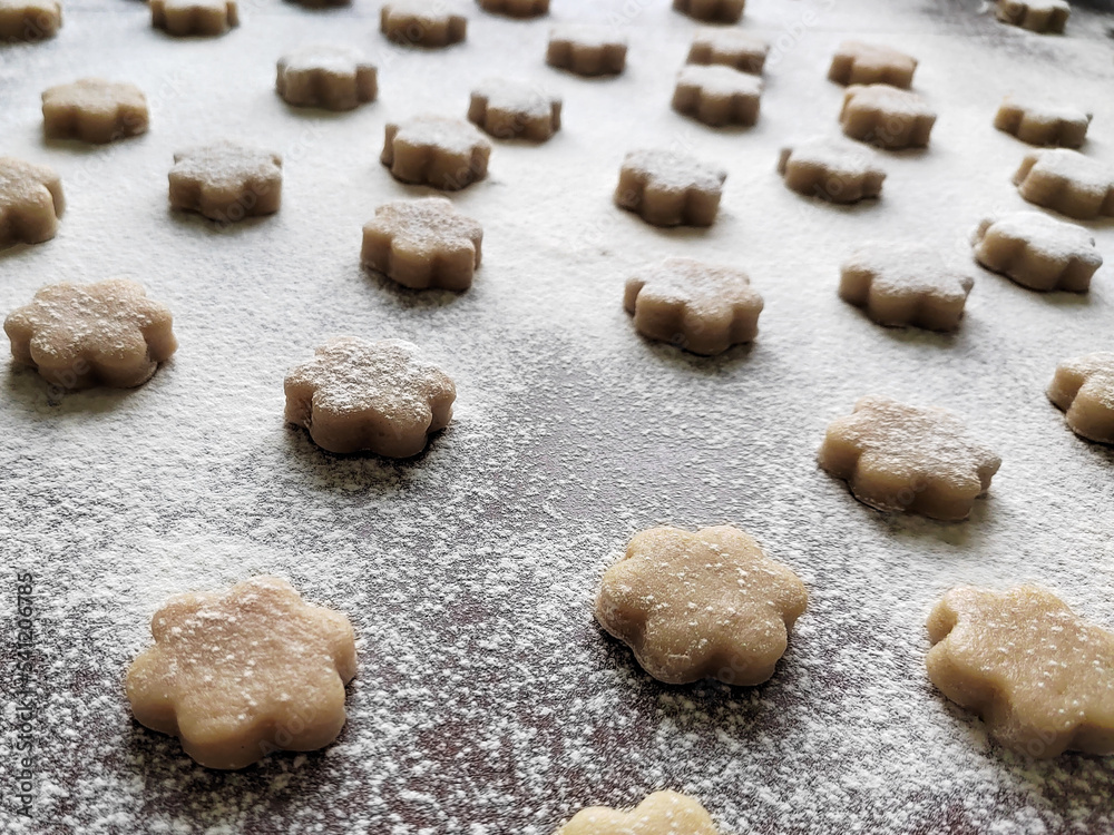 selective focus on raw cookies on brown table