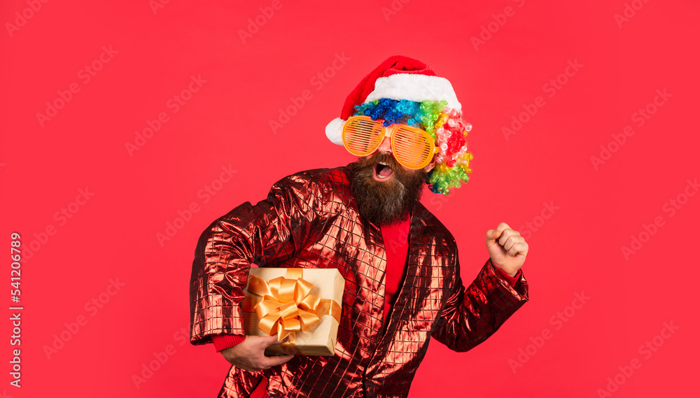 Christmas entertainment ideas. Wishing you peace and prosperity. Cheerful guy colorful hairstyle. Funny man with beard. Winter holidays. Christmas gift. Disco party. Bearded man celebrate christmas
