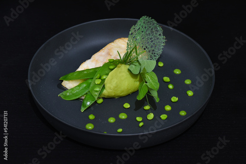 Fresh perch fish fillet on pea puree with quinoa and herbs