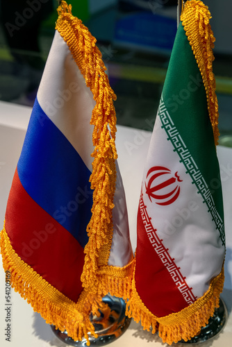 Russian and Iranian flags on the table. The concept of bilateral relations. photo