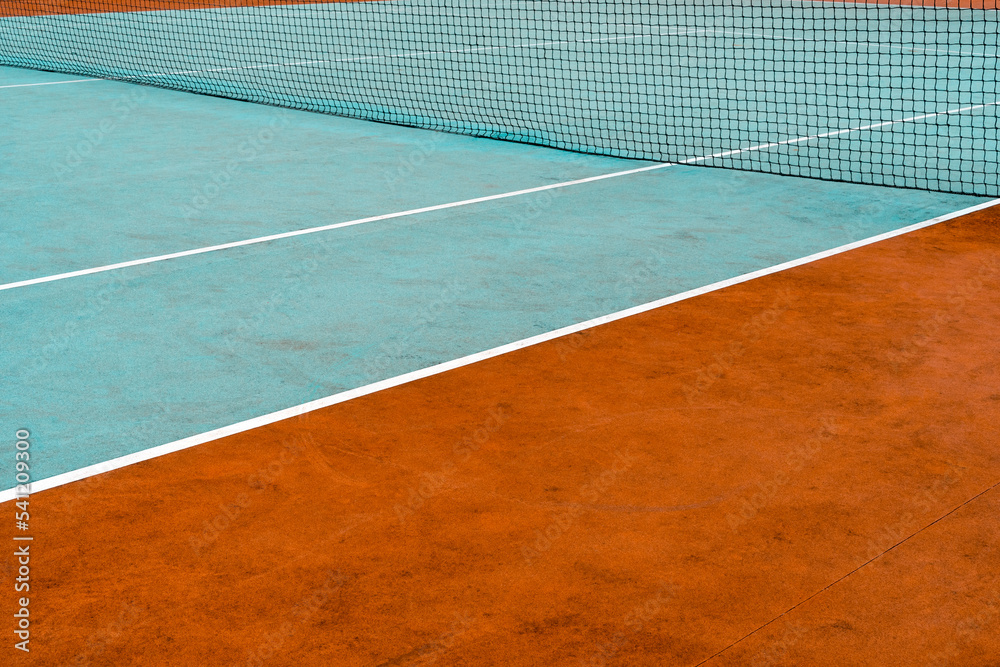 Colorful rubberized tennis court with a mesh