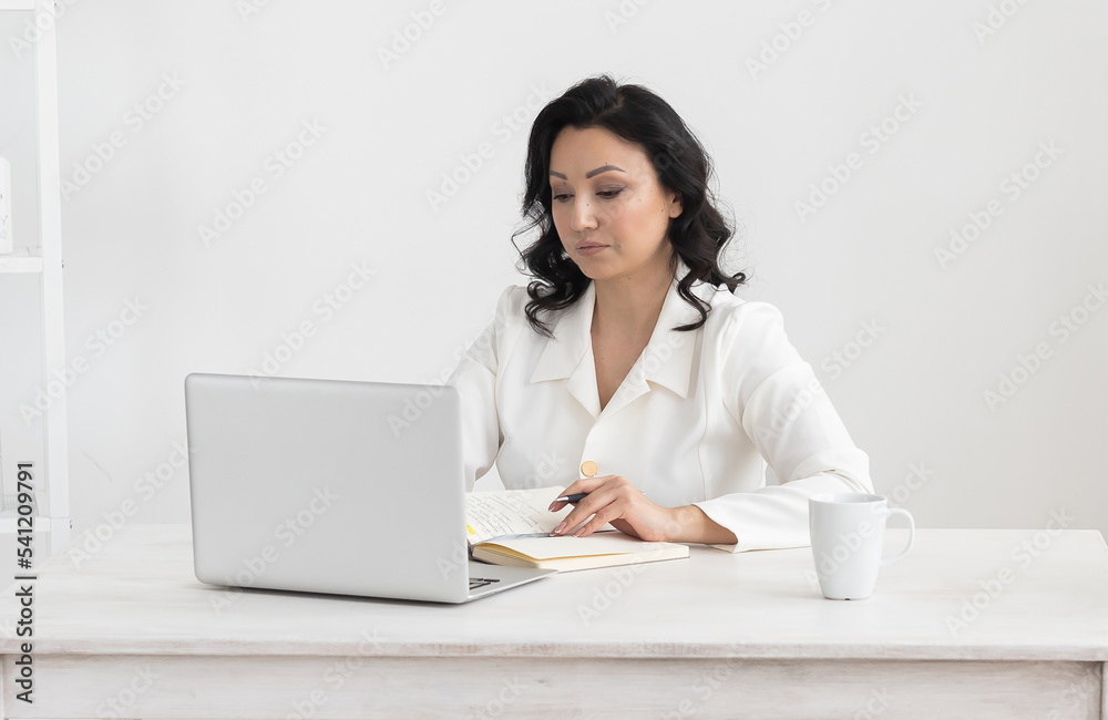 Portrait indian business woman in white suit working in office laptop computer. Small business owner people employee freelance online sme marketing e-commerce telemarketing concept Portrait indian business woman in white suit working in office laptop computer. Small business owner people employee freelance online sme marketing e-commerce telemarketing concept