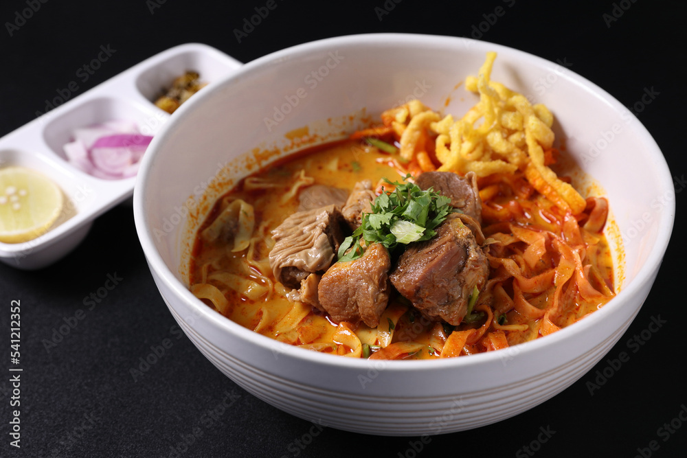 Khao Soi Thai Curry soup isolated in black background Khao Soi Thai Curry soup isolated in black background