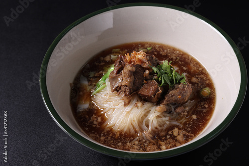 Braised pork noodles Thai street food isolated in black background