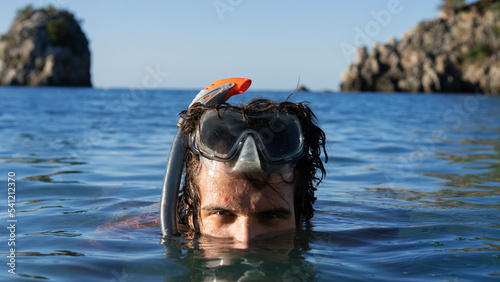 Young man in the sea with the snorkel mask tuba and snorkel. Snorkeling, diving, swimming, vacation concept