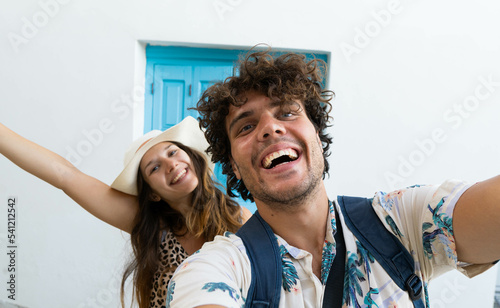 Happy young couple in love taking selfie having fun on vacation in Greece.