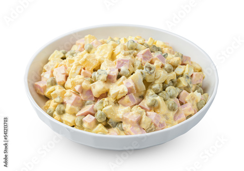 A serving of traditional olivier salad is isolated on a white background. Side view.