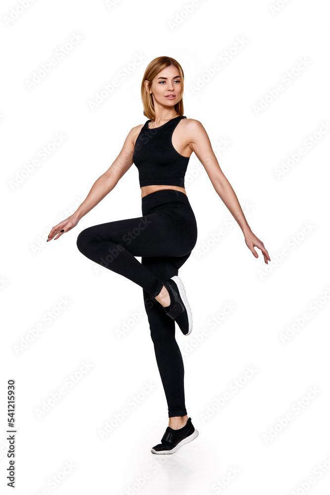 slim woman in black sport leggings and running shoes.