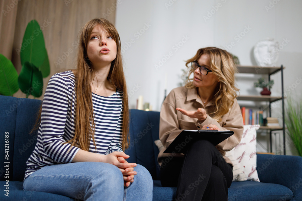 Young depressed woman shares her problems with a psychologist