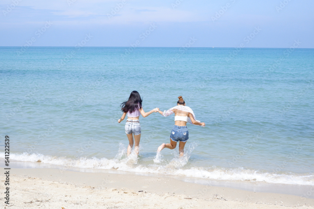 young female tourist playing in the sea with a happy smile. young female tourist playing in the sea with a happy smile.