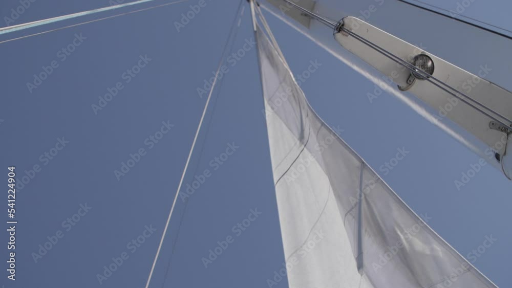 white sail of the yacht develops in the wind white sail of the yacht develops in the wind