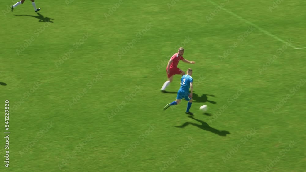 Football Championship: Blue Team Forward Attacks, Kicks the Ball and Scores the Goal. Goalkeeper Fails to Catch Ball. Winning the Match and Game, Players Celebrate Tournament Victory Football Championship: Blue Team Forward Attacks, Kicks the Ball and Scores the Goal. Goalkeeper Fails to Catch Ball. Winning the Match and Game, Players Celebrate Tournament Victory