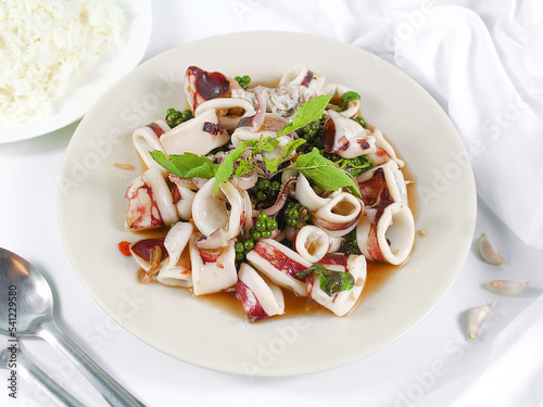 Asian food, Stir Fried Squid with Basil on white plate.