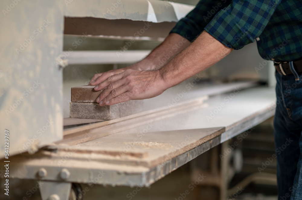 Craft person working with wood in a workshop