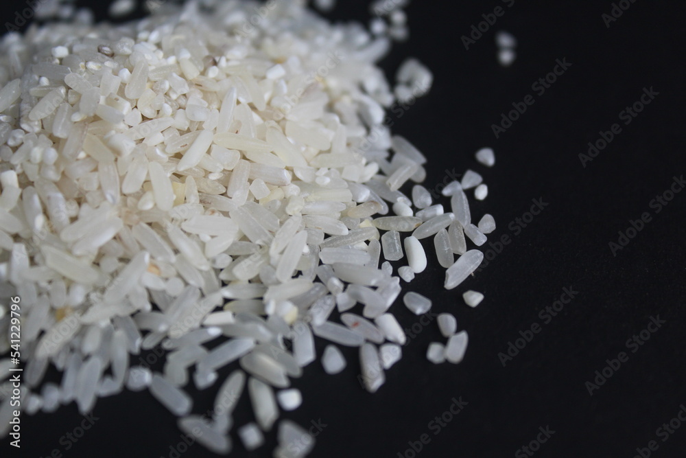 splattered raw rice on a black background splattered raw rice on a black background