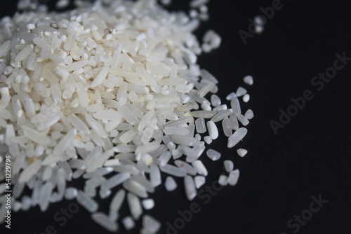 splattered raw rice on a black background