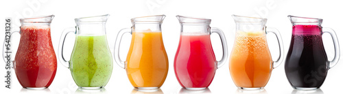 Smoothies of freshly pressed juices in glass pitchers, isolated photo