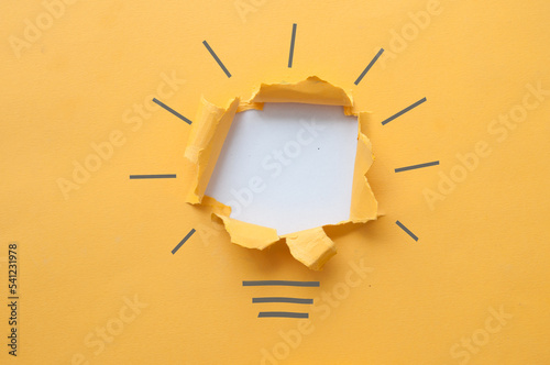 Torn paper light bulb backg...