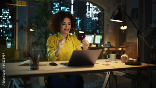 Inspired Multiethnic Female Stretching at Her Desk, Motivated to Start Working on Laptop Computer in Office. Happy Project Manager Writing Creative Texts, Browsing Internet, Shopping Online. photo