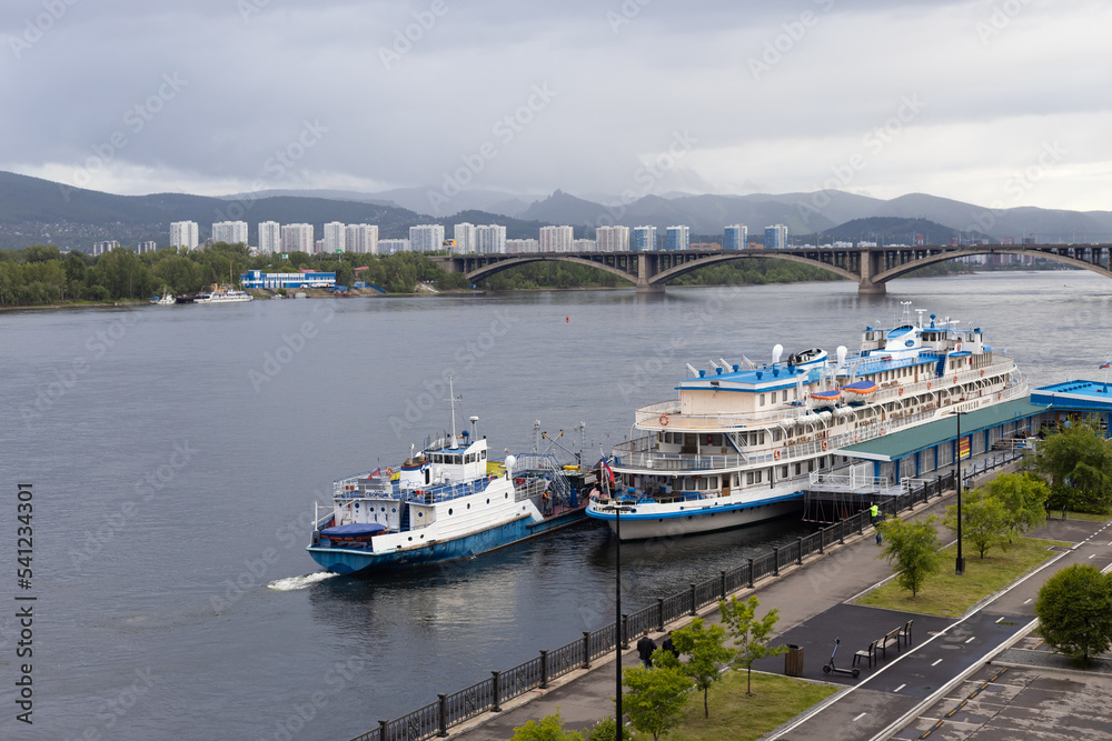 Krasnoyarsk, Russia - June 8, 2022: Tourist river ship 'Alexander Matrosov' in the port of Krasnoyarsk. Performs tourist river cruises along the Yenisei River Krasnoyarsk, Russia - June 8, 2022: Tourist river ship 'Alexander Matrosov' in the port of Krasnoyarsk. Performs tourist river cruises along the Yenisei River