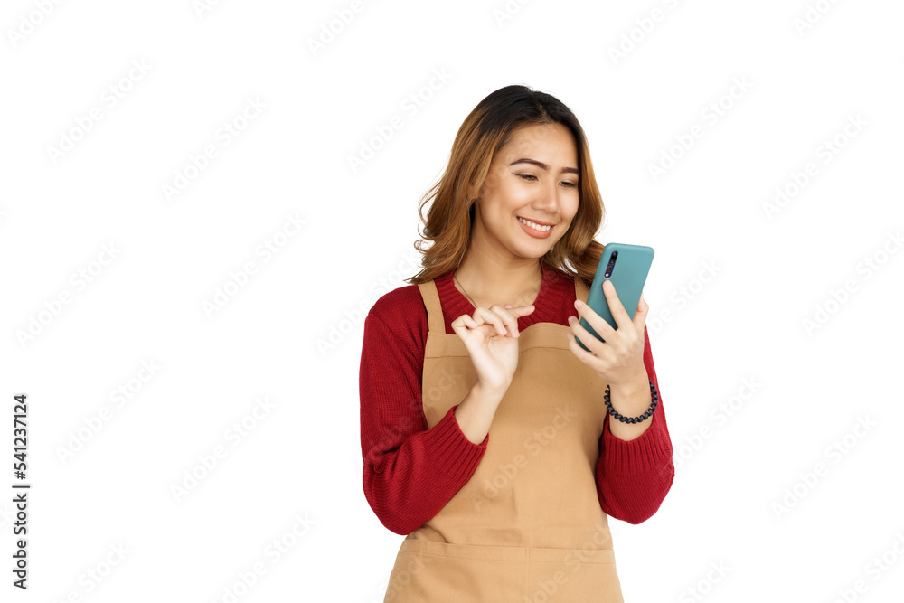 Coffee shop SME owner excited brunette asian woman wearing sweater and apron isolated on white background, Using mobile Coffee shop SME owner excited brunette asian woman wearing sweater and apron isolated on white background, Using mobile