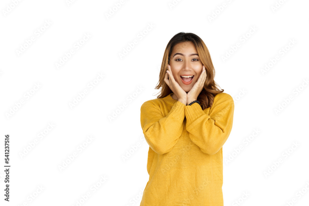 Attractive positive young asian brunette woman in yellow sweater on white background. shocked or surprise Attractive positive young asian brunette woman in yellow sweater on white background. shocked or surprise