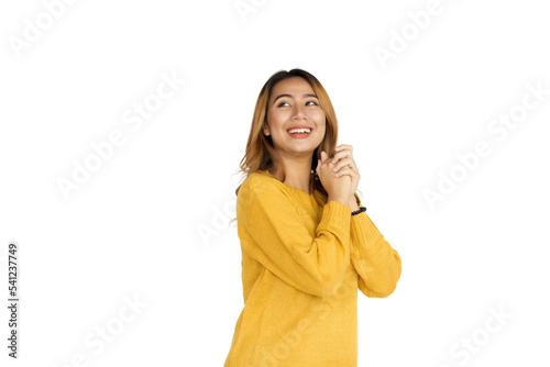 Attractive positive young asian brunette woman in yellow sweater on white background.