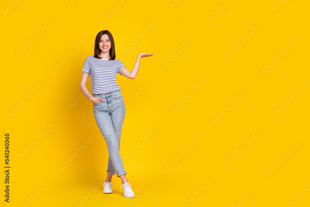 Full size photo of pretty nice slim lady arm open show empty space offer good prices quality clothes isolated on yellow color background