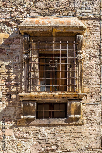 Ancient window with metal grill and stone cills in Italy photo